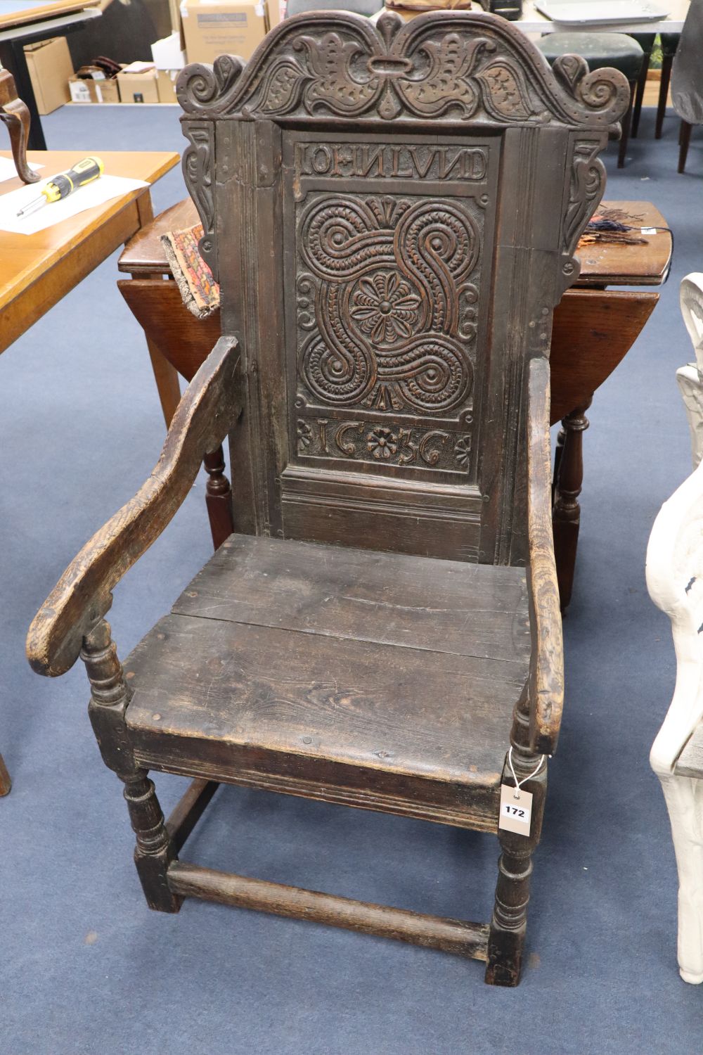 A Charles I oak panel back Wainscot chair, the central panel carved JOHN LUND 1636, some alterations, width 57cm height 111cm